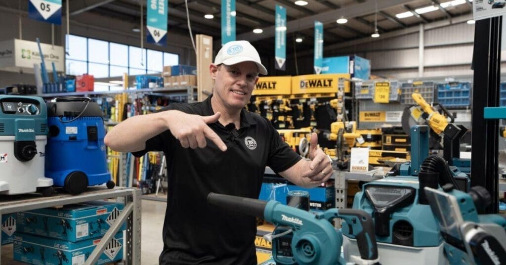 CBS Co-op team member in a trade supplies store alongside Makita and DeWalt power tools